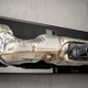 The Porsche Design 911 Soundbar 2.0 Pro hanging on a concrete wall.